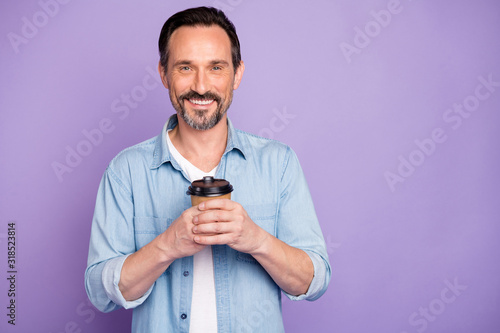 Portrait of cheerful man have free time after work day hold take-out cup with hot americano cappuccino wear good looking shirt isolated over violet color background © deagreez