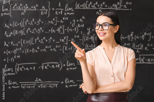 Female teacher near blackbo...