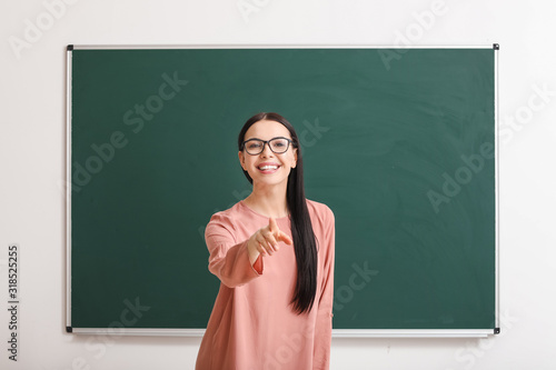 Female teacher near blackbo...