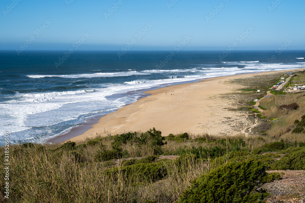 Praia do Norte beach in Nazare Portugal in the winter sunshine
