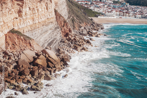 Waves crash near the scenic cliffs of Nazare, Portugal