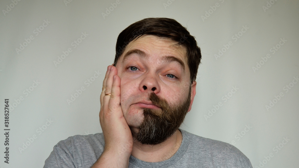 The person is upset, sad. without his thick, natural beard. Humor, joke. The person is upset, sad. without his thick, natural beard. Humor, joke.
