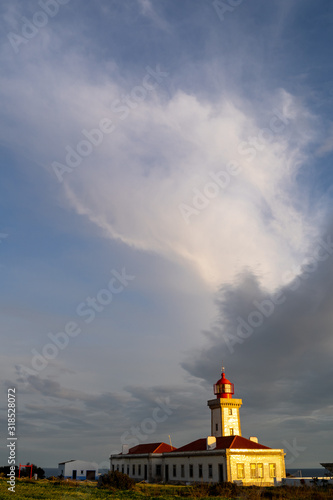 Negative space and sky landscape view of the Alfanzina Lighthouse, near the town of Carvoeiro Portugal in the Algarve region