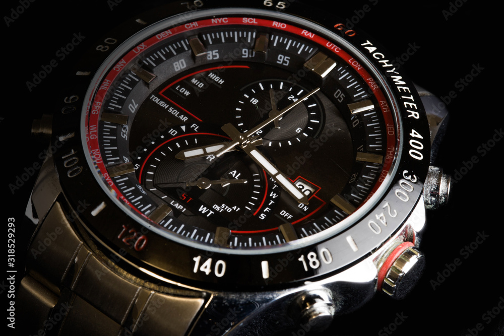 Luxury sport chronograph black Analog Men's Watch silver red steel for men luxury on black background - detail view Luxury sport chronograph black Analog Men's Watch silver red steel for men luxury on black background - detail view