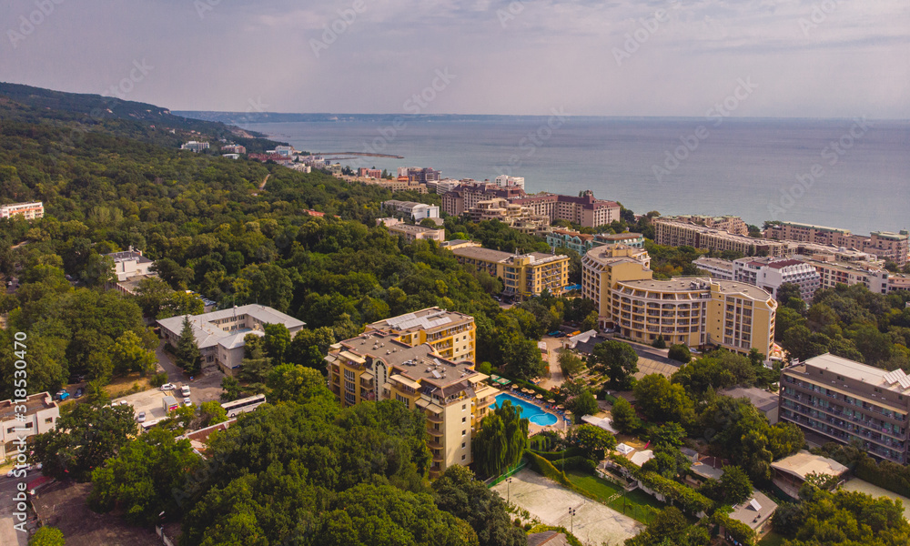 Aerial image a drone resort Golden Sands on Black Sea coast in Bulgaria. Many hotels and beaches with tourists, sunbeds and umbrellas.