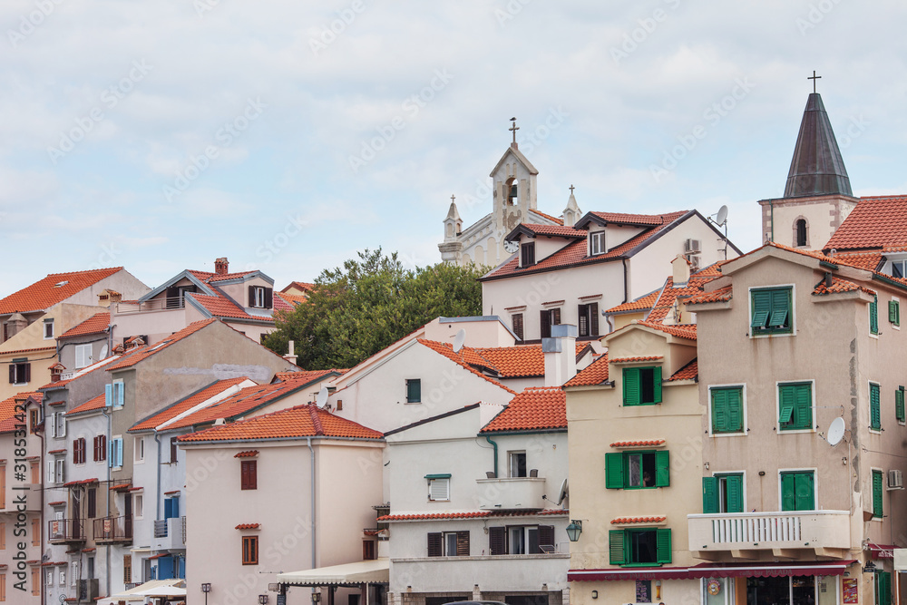 City view of traditional sea town in Croatia  with red tiled roofs and light  houses