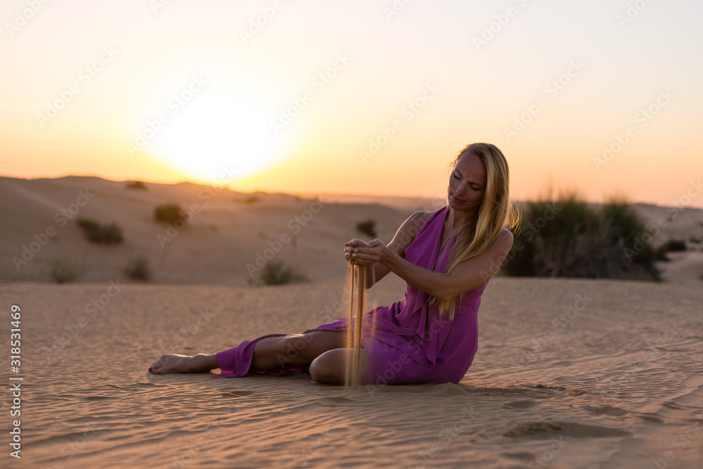 Blonde model in the desert in Emirates