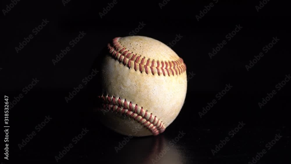 A baseball spinning on a black background. 4K A baseball spinning on a black background. 4K