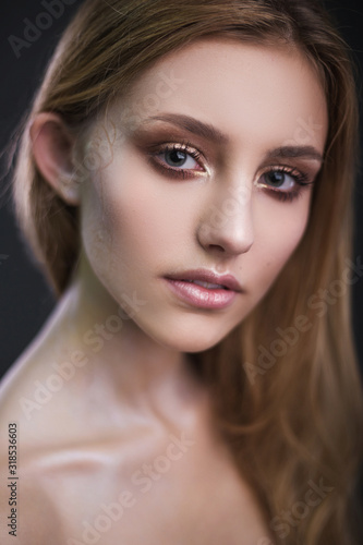 Studio portrait of a model. Body art gray roses. Beautiful girl on gray background