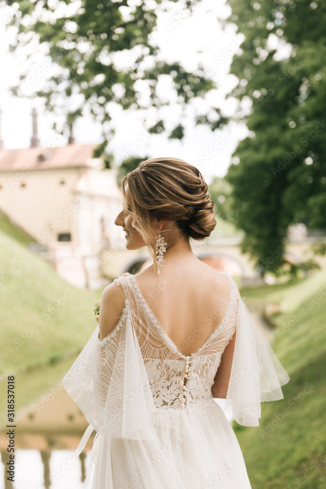 Beautiful elegant bride on the background of an old castle, European wedding Beautiful elegant bride on the background of an old castle, European wedding