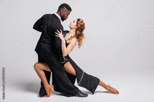 Couple dancers posing over white background. Dance school concept