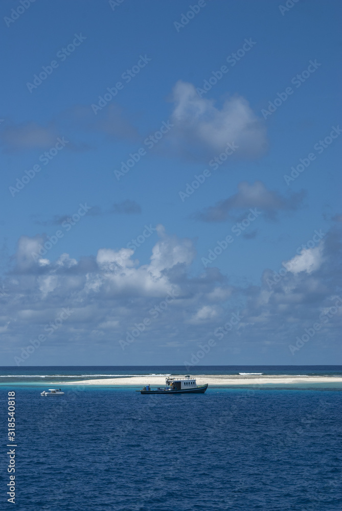 Motor boat on clear turquoise water... Maldives