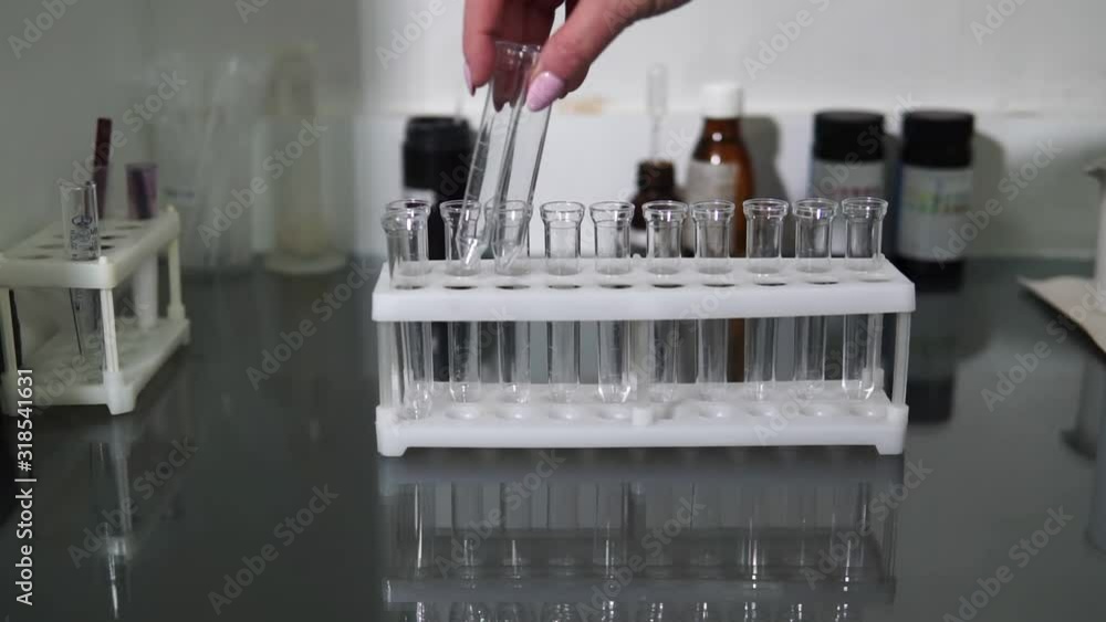 A female lab assistant is preparing test tubes for a blood test. Medical laboratory. A female lab assistant is preparing test tubes for a blood test. Medical laboratory.