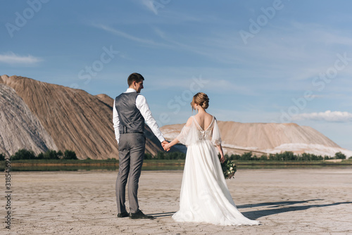 Beautiful elegant couple of newlyweds in love on a beautiful natural background of salt mountains and quarries
