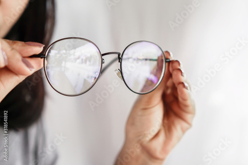 woman hand hand holding eyeglasses closeup ,eye care concept 