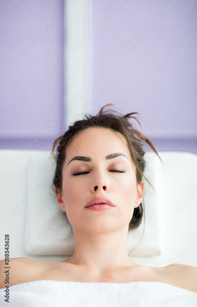 Relaxed woman is sitting in chair of beauty salon waiting for anti-aging treatments or an injection of hyaluronic acid Relaxed woman is sitting in chair of beauty salon waiting for anti-aging treatments or an injection of hyaluronic acid