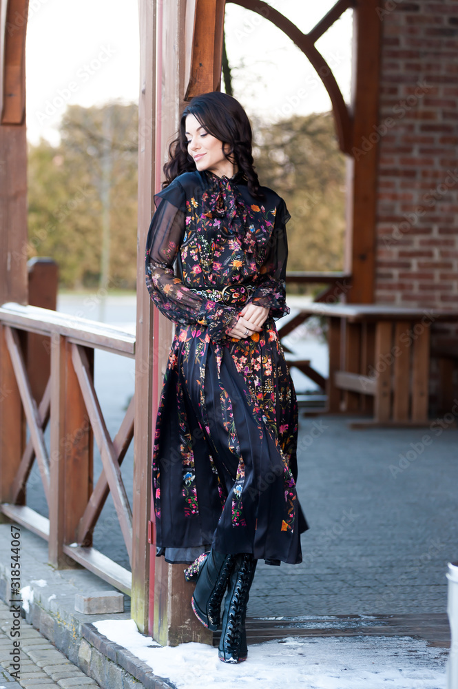 Beautiful european woman posing in dress outdoor in winter Beautiful european woman posing in dress outdoor in winter