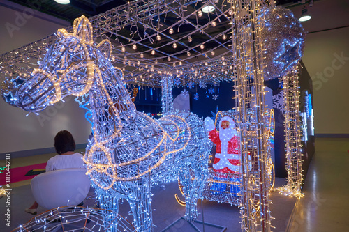 Illumination of Santa Claus in a cart on deer for Christmas