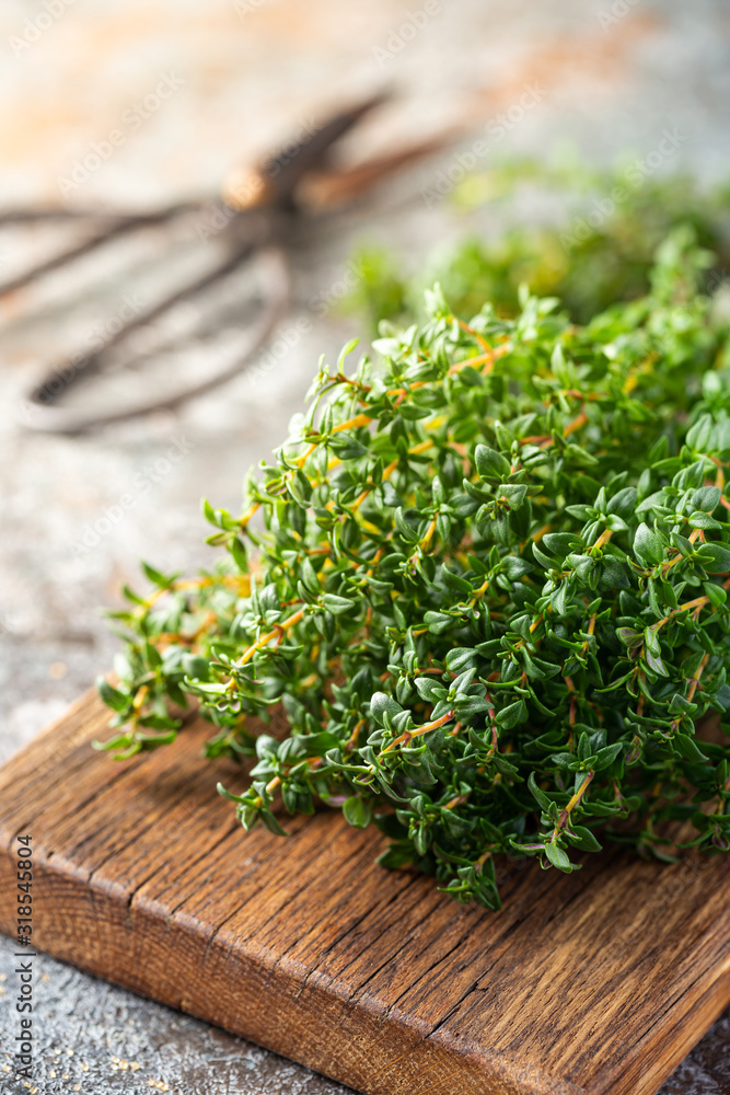 Bunch of fresh thyme herb on old wooden board Bunch of fresh thyme herb on old wooden board