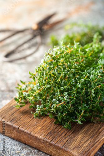 Bunch of fresh thyme herb on old wooden board