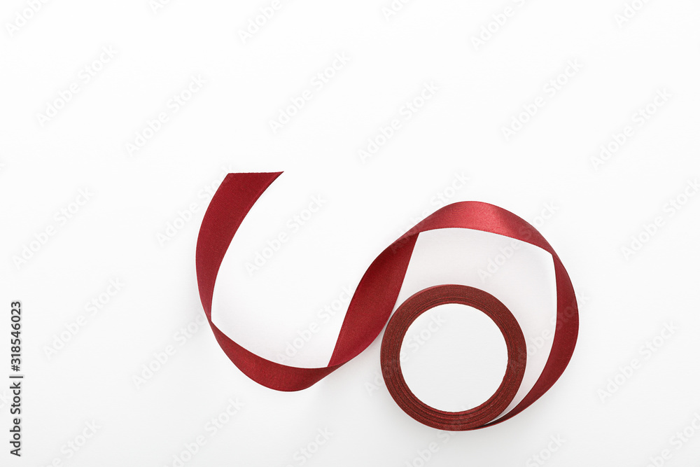 top view of satin burgundy decorative curved ribbon isolated on white top view of satin burgundy decorative curved ribbon isolated on white