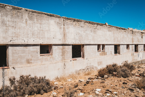 abandoned building ruin exterior in desert landscape