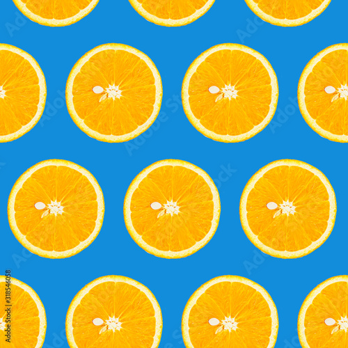 Slices of orange on a classic blue background  top view. Isolated  seamless pattern.