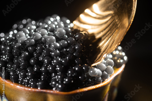 Black caviar and spoon close-up photo