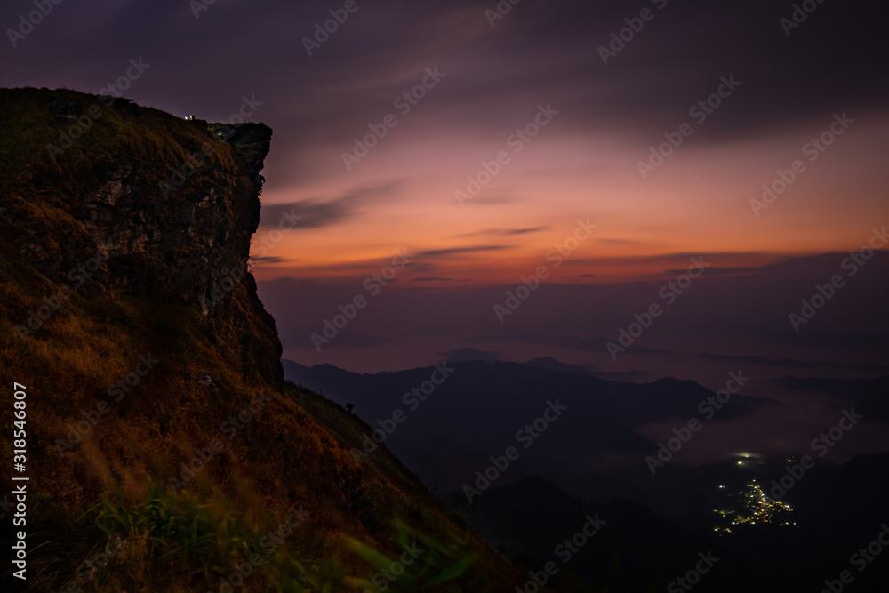 Dawn at Phu Chi Fah with the light from village below Dawn at Phu Chi Fah with the light from village below