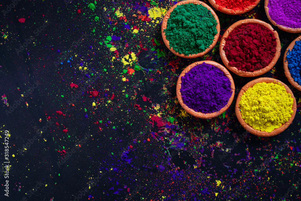 Indian Festival Holi, Colors in wooden bowl on dark background 