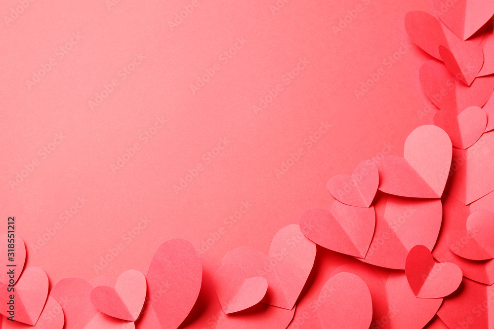 Cut out of red paper hearts on red background