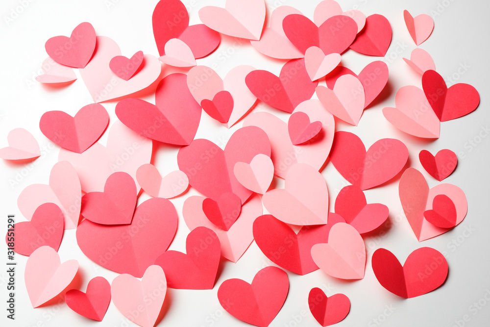 Bunch of cut out of pink and red paper hearts on white background. Bunch of cut out of pink and red paper hearts on white background.