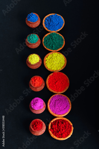 Indian Festival Holi , Colors in wooden bowl on dark background