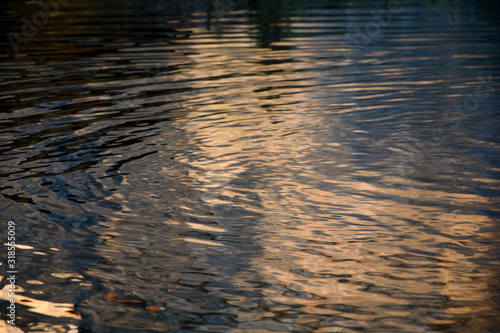 Rippled water surface by sundown © Claudia Evans 