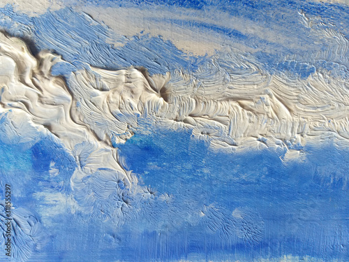 Beautiful light blue and white background. Abstract hand painted sky.