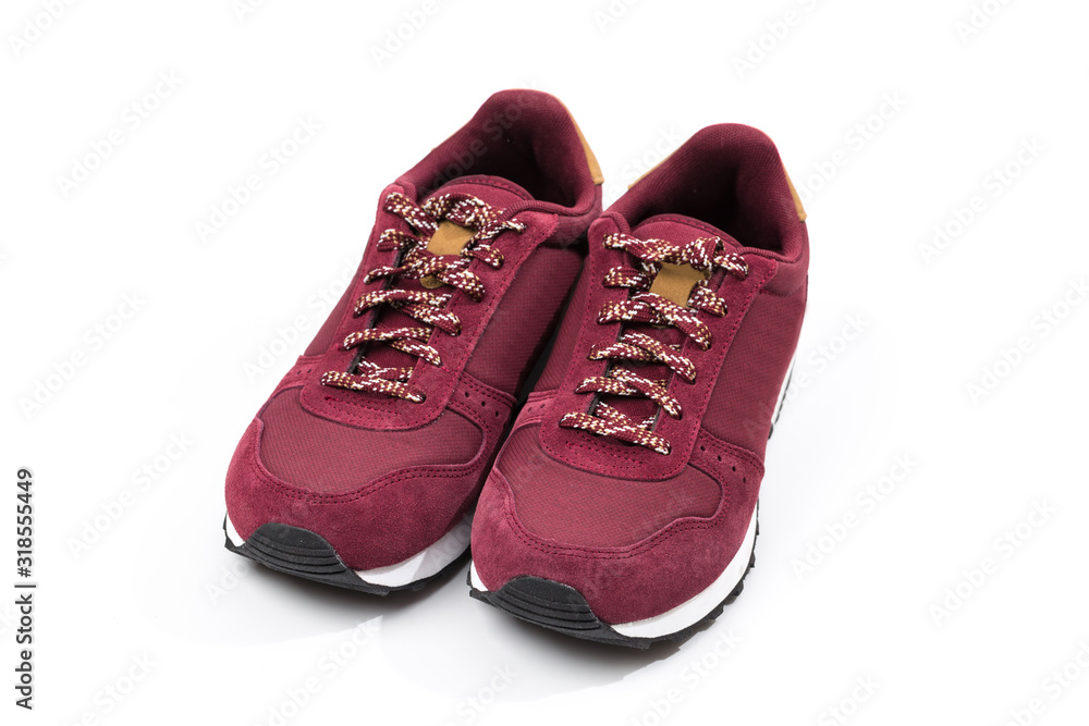 a pair of new burgundy, cherry sneakers or athletic shoes isolated on a white background. a pair of new burgundy, cherry sneakers or athletic shoes isolated on a white background.