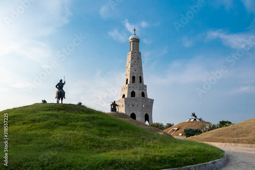 wide shot of fateh burj with sikh warrior statue against blue sky in the background. historical monument concept.