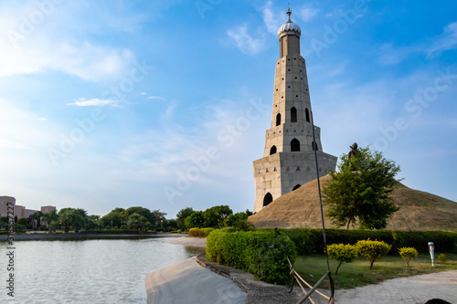 Photography wide shot of fateh burj with lake against blue sky in the background
