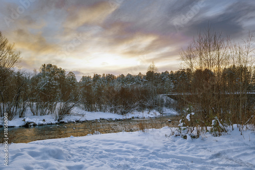 Wallpaper Mural Winter landscape at sunset by a snowy forest lake. Winter forest. Torontodigital.ca