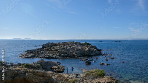 Tourists on a clear sunny winter day on the Mediterranean coast. Hiking trails near Roses. Picturesque landscapes, beautiful places. Winter holidays in Catalonia.