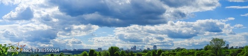 Fantastic sky over Moscow city in summertime. Panoramic view blue cloudy sky and white and rainy clouds.