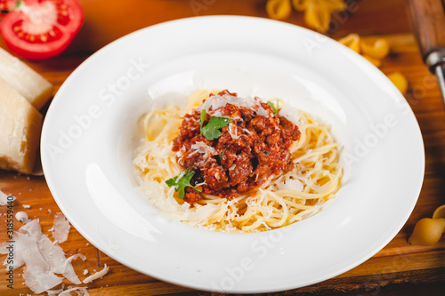 Spaghetti bolognese with tomato sauce, minced meat and grated parmesan cheese. Italian pasta.