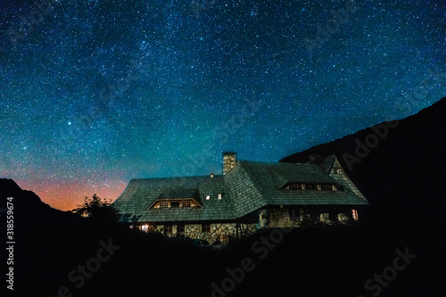 Fototapeta Naklejka Na Ścianę i Meble -  a shelter  for tourists in Tatras mountains at night under star sky , Poland, dolina 5 stawów,Zakopane