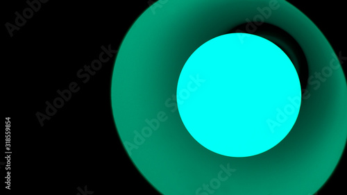 Close-up of a lamp with green light on a black background.