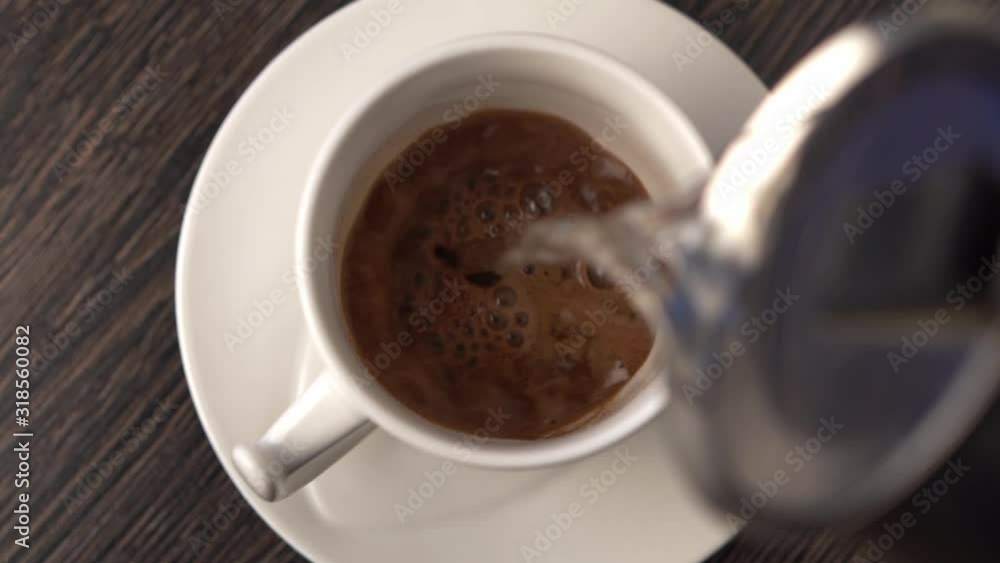 Making instant black coffee or hot chocolate. Person add pour hot water Making instant black coffee or hot chocolate. Person add pour hot water