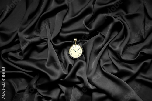 round clock on a black background photo