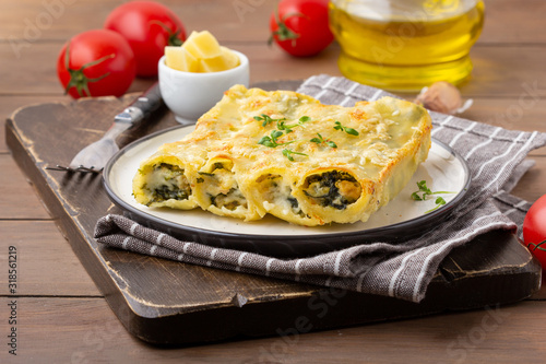 Italian cannelloni pasta with ricotta and spinach, traditional delicious food with cheese