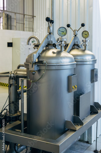 Cylinder with gas in and hop dispenser with manometers in modern brewery
