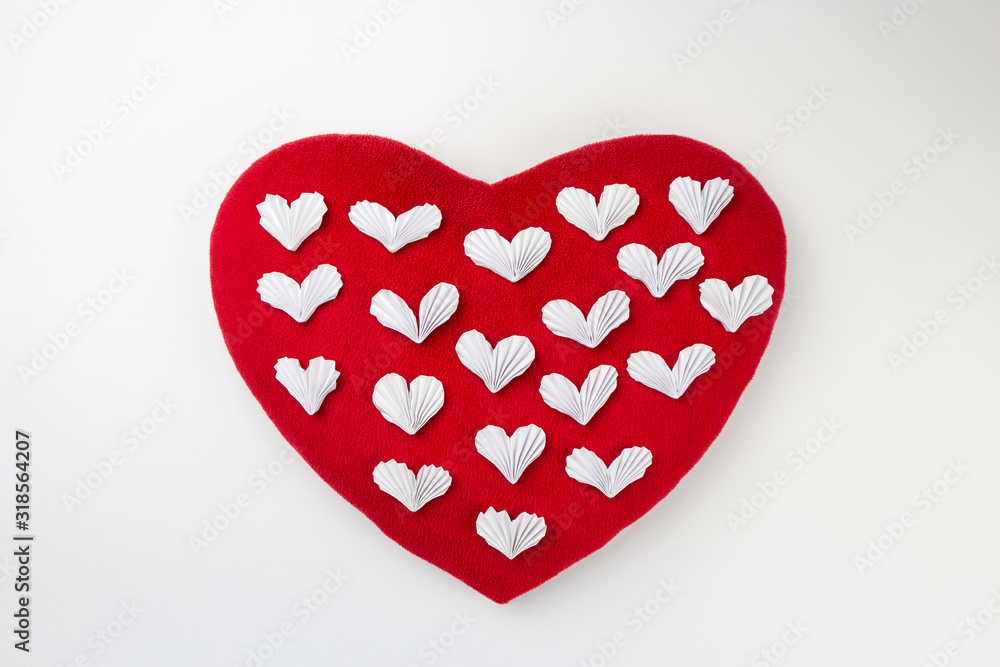 Small white paper hearts on a big soft red heart. Small white paper hearts on a big soft red heart.