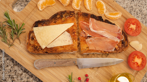 Mediterranean breakfast. Toast with ham and cheese and others ingredients, rustic and healthy. photo